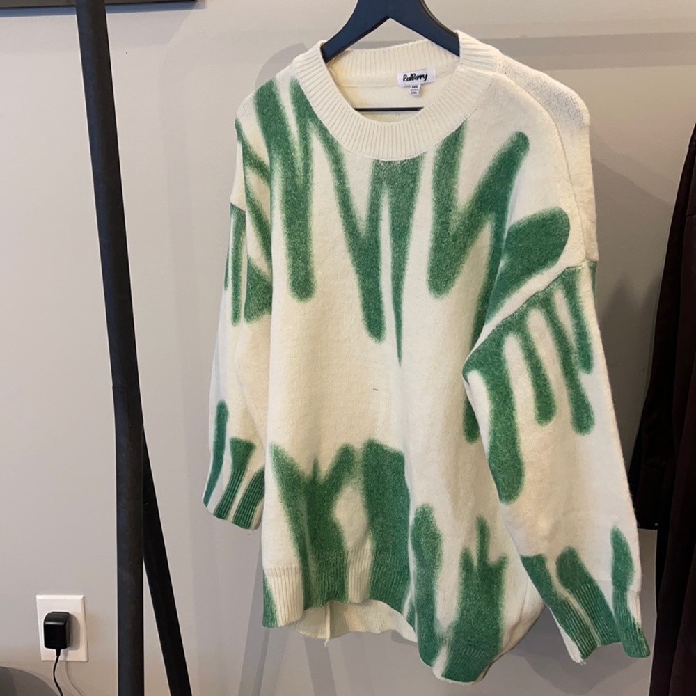 green and white designed sweater